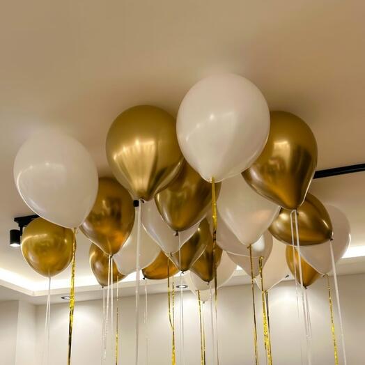 White and gold balloons beneath the ceiling.